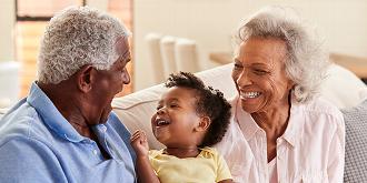 Smiling grandparents spending time with grandchild